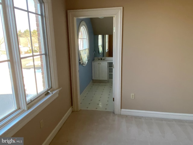 doorway featuring a healthy amount of sunlight and light colored carpet