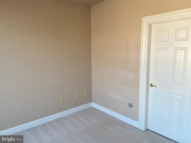 unfurnished room featuring light colored carpet