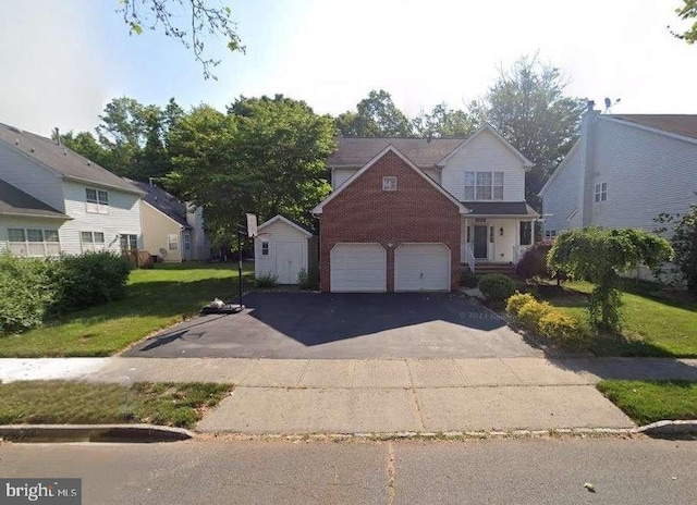 view of front of home with a garage, a storage shed, and a front lawn