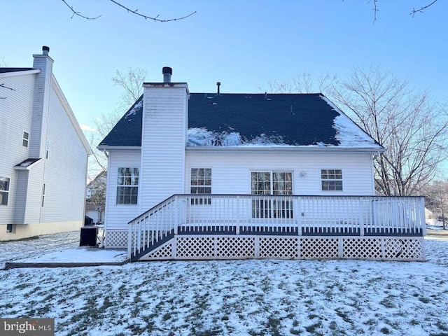 snow covered property featuring a deck