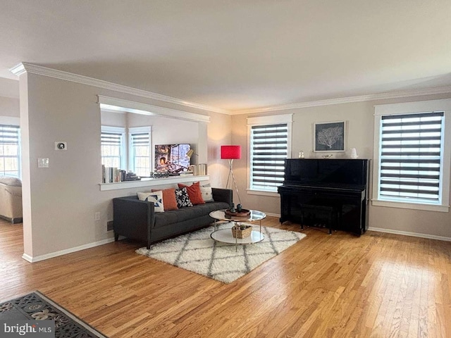 living room with light wood-type flooring and ornamental molding