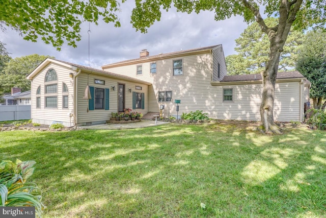 rear view of house with a yard