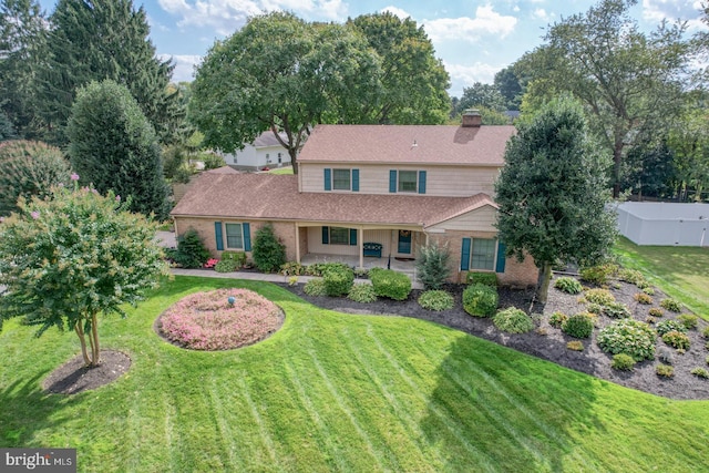 view of front of home with a patio area and a front yard