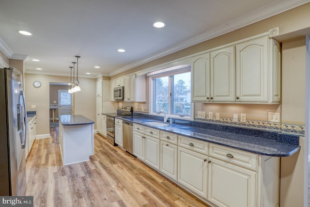 kitchen with sink, ornamental molding, a kitchen island, pendant lighting, and stainless steel appliances