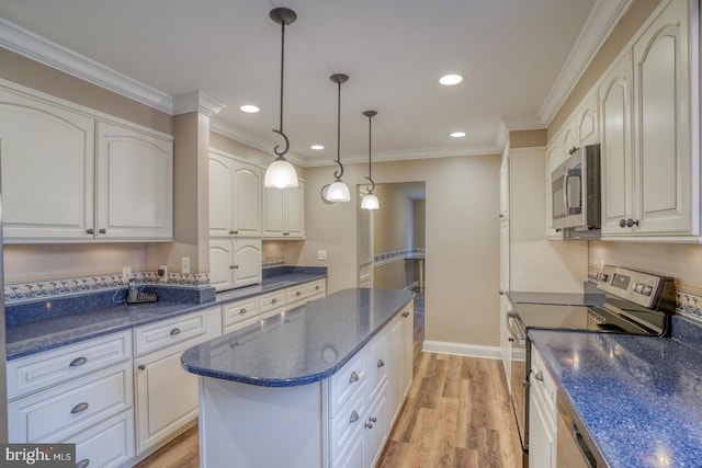 kitchen with decorative light fixtures, white cabinetry, a center island, stainless steel appliances, and light hardwood / wood-style flooring