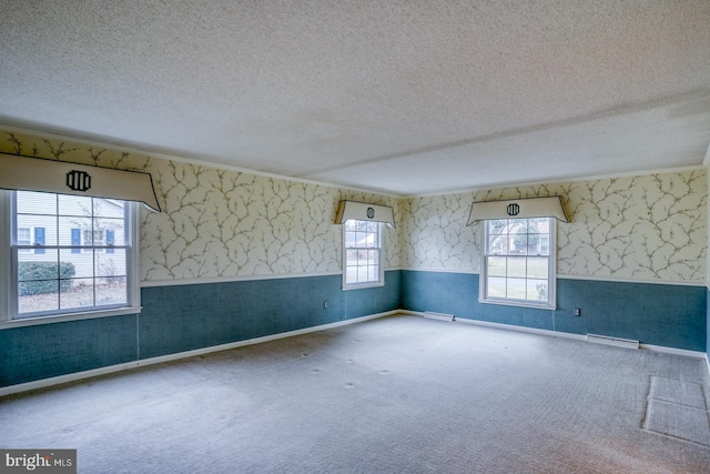 carpeted spare room with a textured ceiling