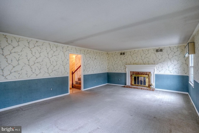 unfurnished living room with carpet floors and a fireplace