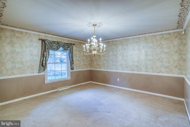 carpeted spare room featuring ornamental molding and a chandelier