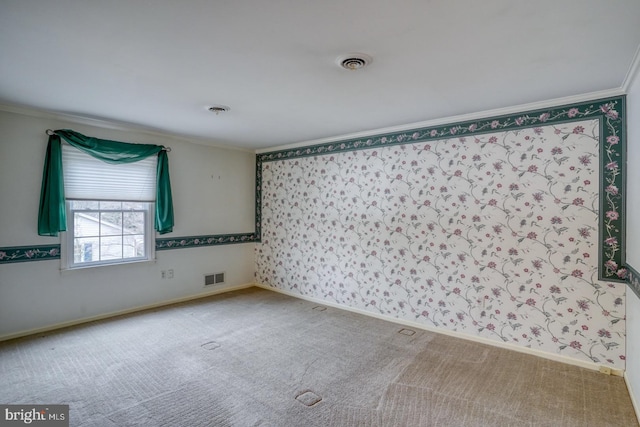 carpeted empty room featuring ornamental molding