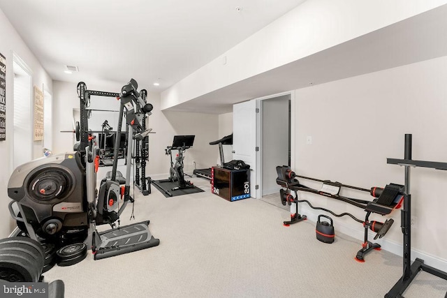 workout room featuring light colored carpet