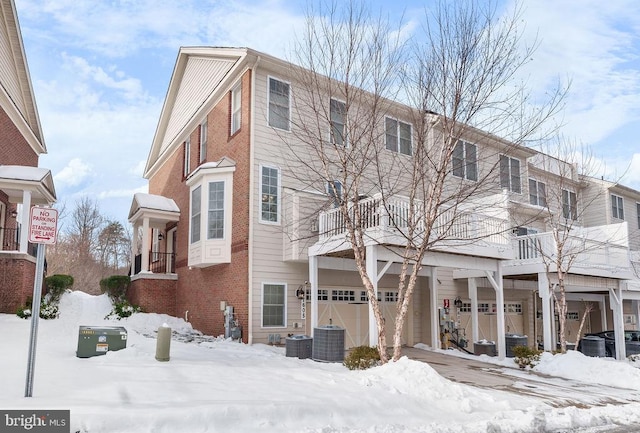 view of front of home featuring central AC unit and a garage