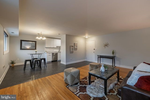 living room featuring a chandelier and dark wood-type flooring