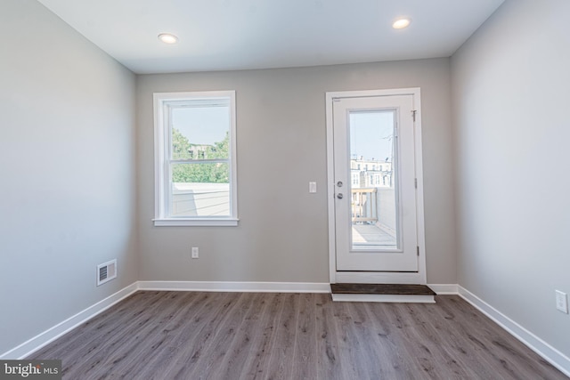 doorway to outside with wood-type flooring