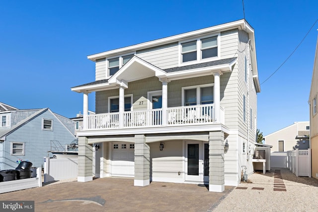 view of front facade with a balcony and a garage