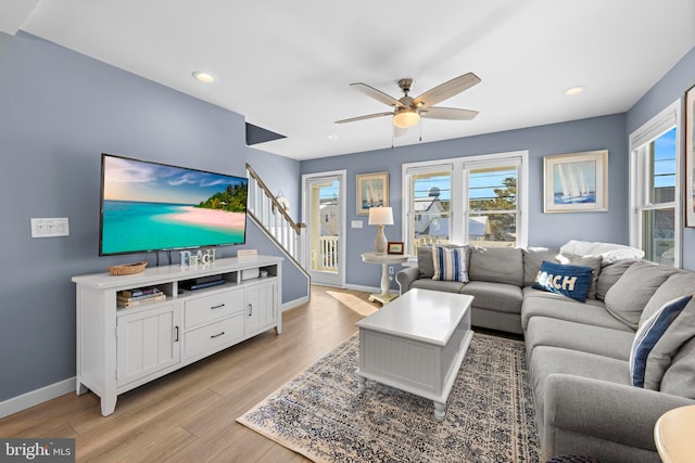 living room featuring ceiling fan and light wood-type flooring