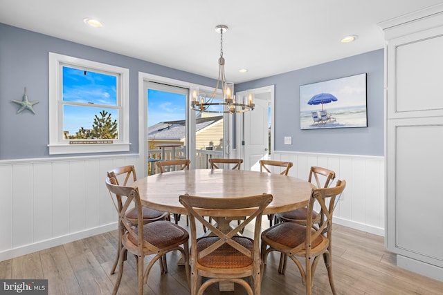 dining area featuring light hardwood / wood-style floors and a chandelier