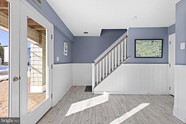 foyer entrance with light hardwood / wood-style flooring