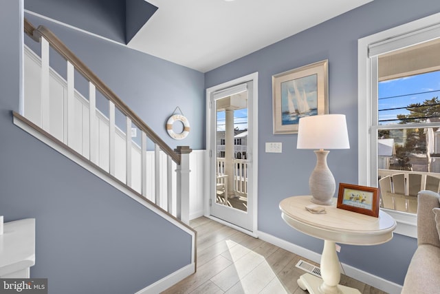 entryway with light hardwood / wood-style floors and ceiling fan