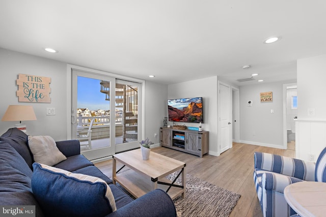 living room with light hardwood / wood-style floors and a wealth of natural light