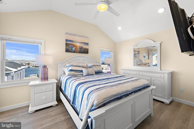 bedroom with light hardwood / wood-style floors, ceiling fan, and lofted ceiling