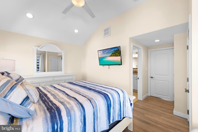 bedroom with ceiling fan, light wood-type flooring, and vaulted ceiling