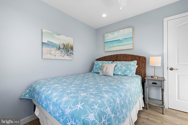 bedroom with ceiling fan and light hardwood / wood-style flooring