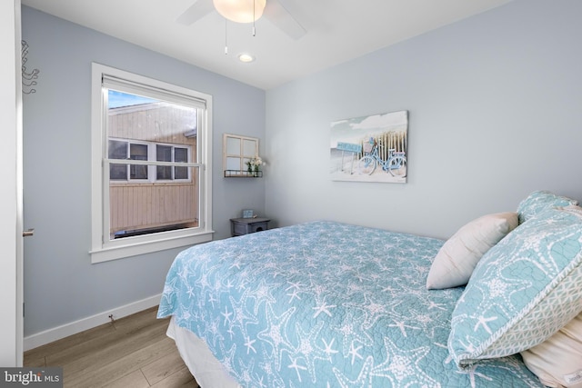 bedroom with hardwood / wood-style floors and ceiling fan