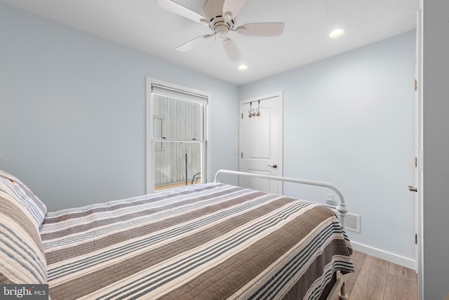 bedroom with ceiling fan and light hardwood / wood-style flooring