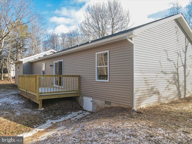 rear view of property featuring a deck