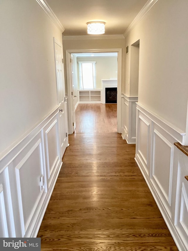 hall featuring dark wood-type flooring and ornamental molding