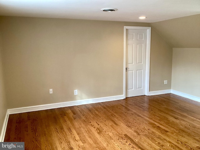 bonus room featuring vaulted ceiling and hardwood / wood-style flooring