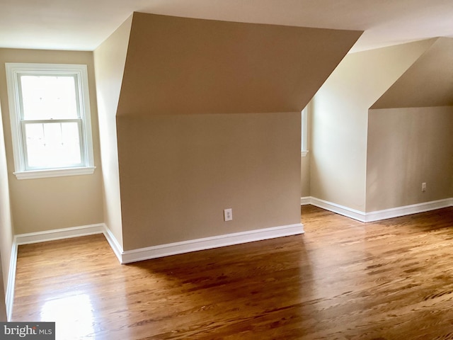 additional living space featuring hardwood / wood-style flooring