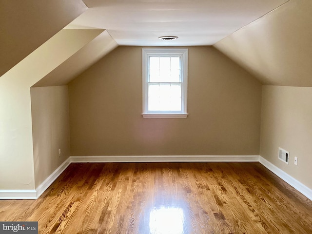 bonus room featuring vaulted ceiling and hardwood / wood-style floors