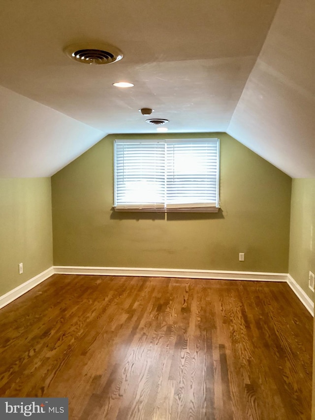 bonus room featuring wood-type flooring and vaulted ceiling