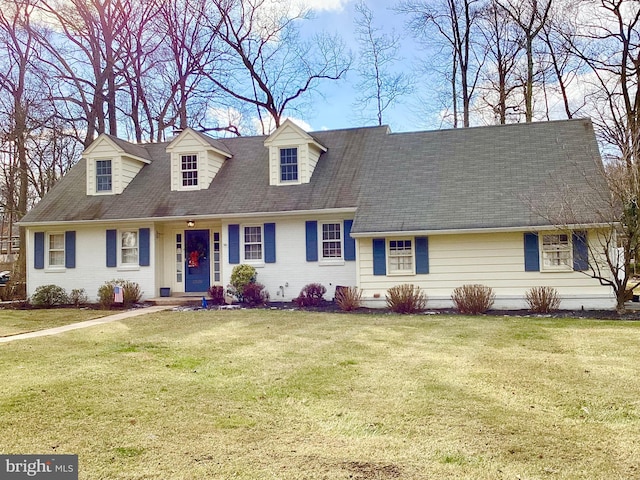 cape cod home with a front yard