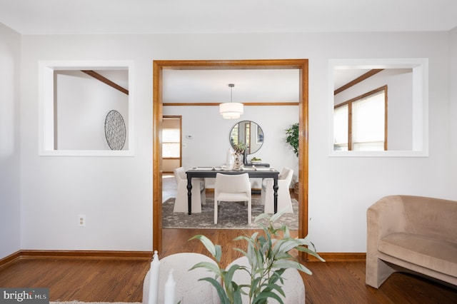 interior space featuring baseboards and wood finished floors