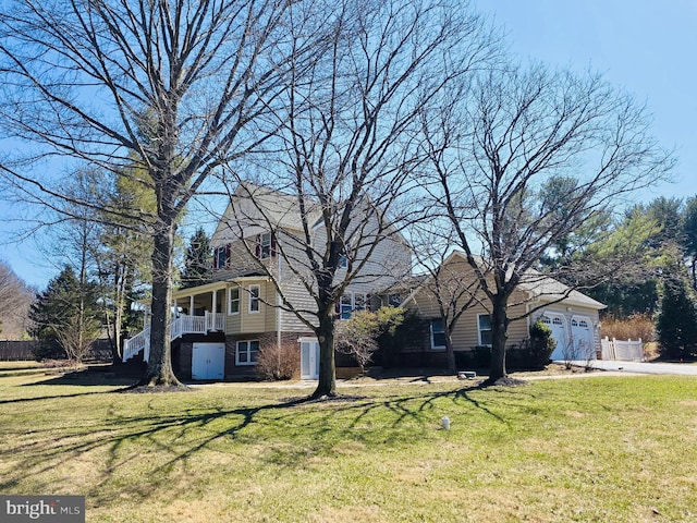 view of front of house with a garage, driveway, and a front yard