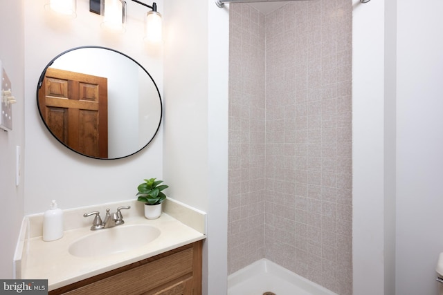 full bath with a shower stall and vanity