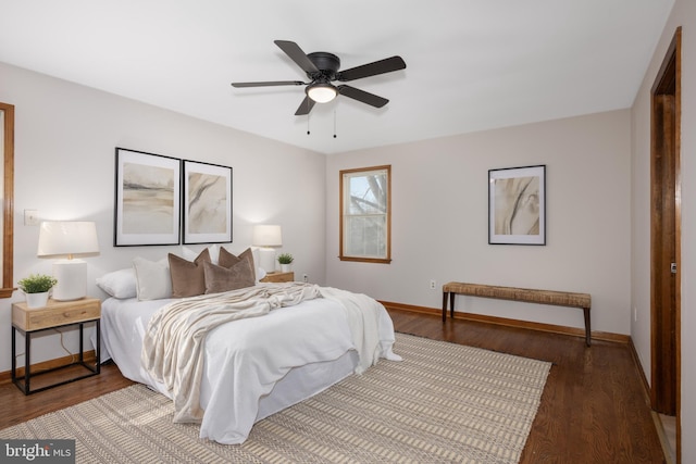 bedroom featuring ceiling fan, baseboards, and wood finished floors