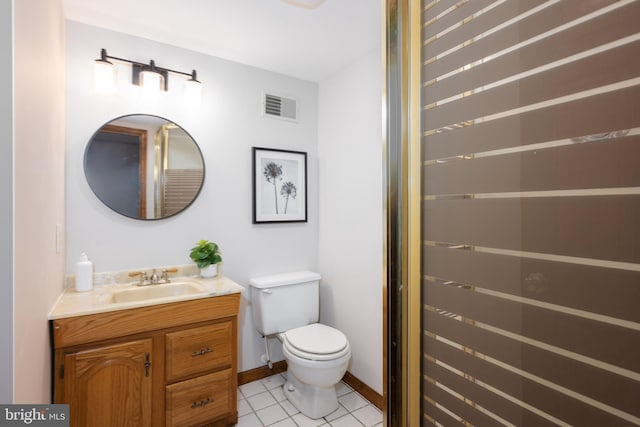 bathroom featuring tile patterned flooring, visible vents, baseboards, toilet, and vanity