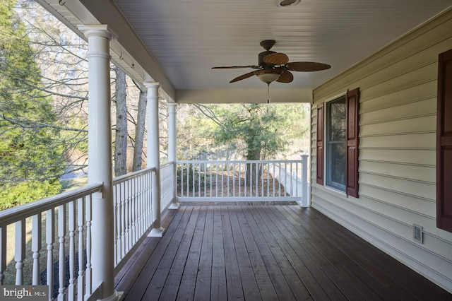 wooden terrace featuring a ceiling fan