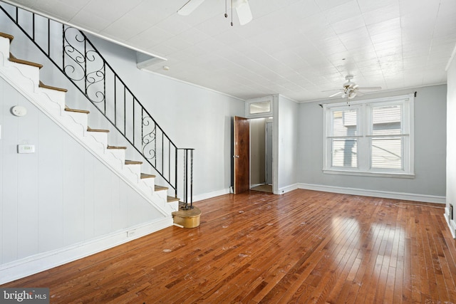 unfurnished living room with ceiling fan and wood-type flooring