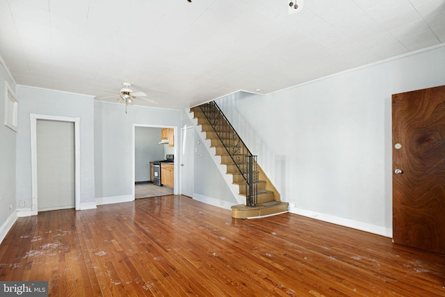 unfurnished living room featuring ceiling fan, ornamental molding, and hardwood / wood-style floors