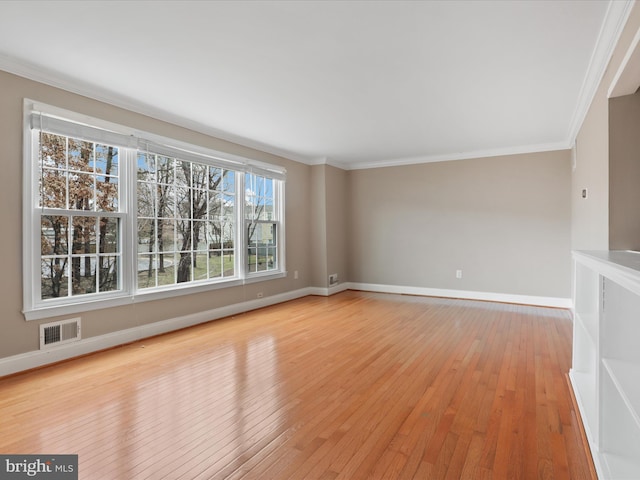 unfurnished living room featuring ornamental molding and light hardwood / wood-style floors