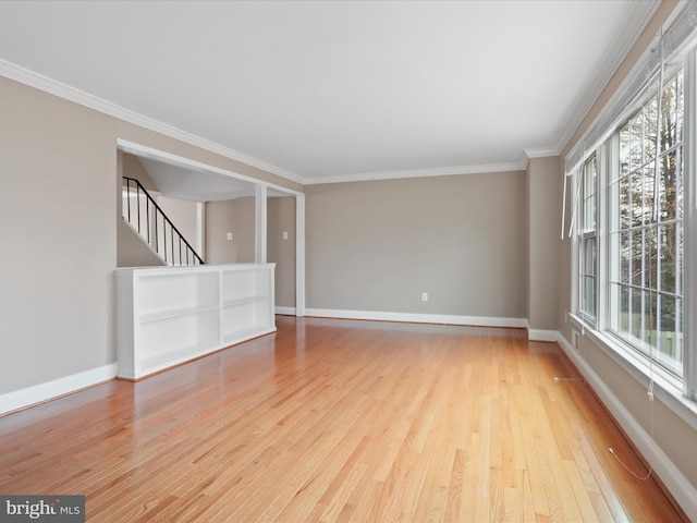 unfurnished room with ornamental molding and light hardwood / wood-style floors