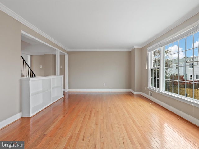 unfurnished room with crown molding and light hardwood / wood-style floors