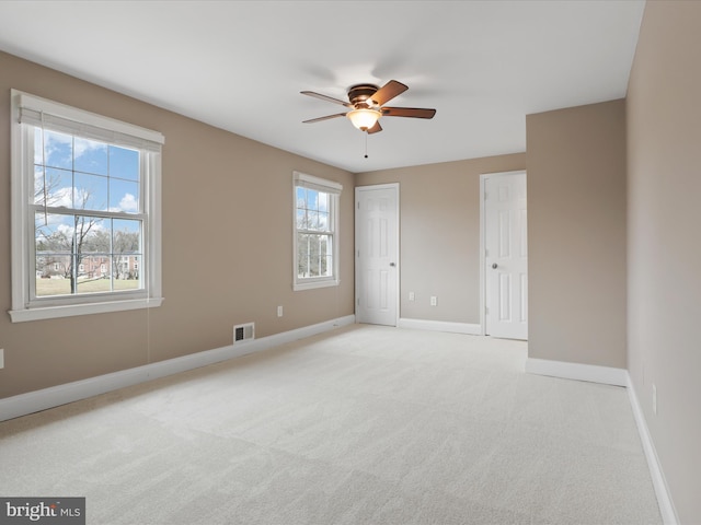 unfurnished bedroom with light carpet and ceiling fan