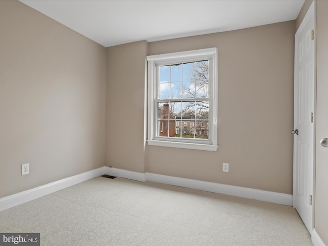 spare room with light colored carpet