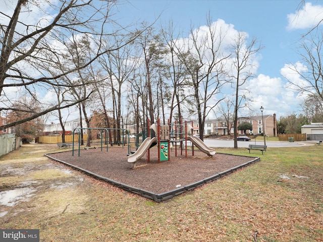 view of jungle gym with a lawn