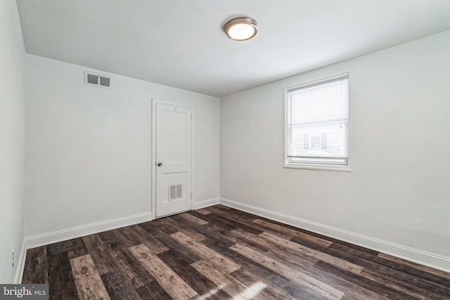 spare room featuring dark hardwood / wood-style floors